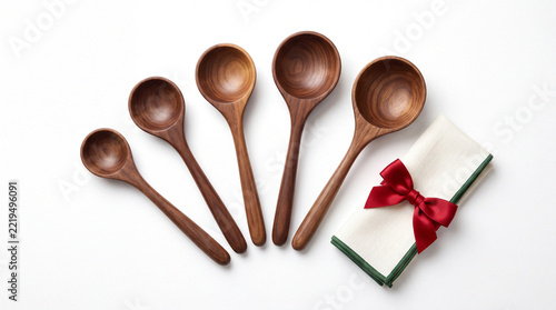 Five wooden measuring spoons isolated on white background.