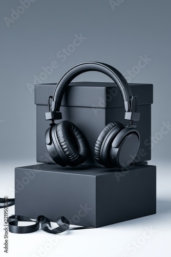 Black Over Ear Headphones on Boxes with Dark Ribbon
