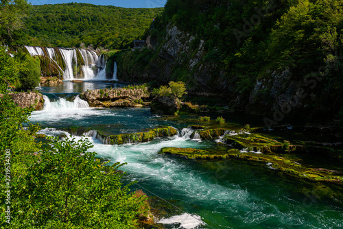 Cascading terraces of Strbacki Buk waterfall flowing through emerald river, Bosnia