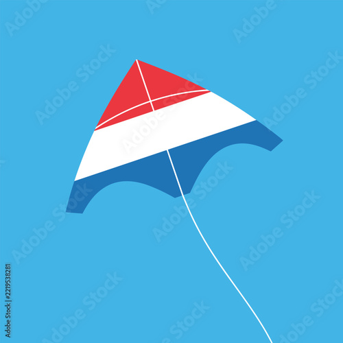 A vibrant red, white, and blue kite soars gracefully against a clear, expansive blue sky, symbolizing freedom and lighthearted celebration.