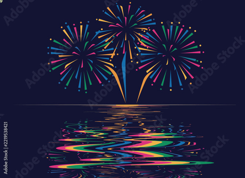 A spectacular display of vibrant, multicolored fireworks explodes dramatically over a serene body of water, casting dazzling reflections on its surface.
