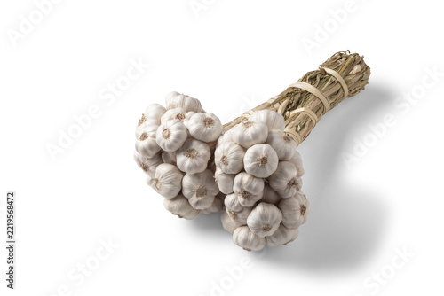 High angle view of a bunch of garlic separated a white background.