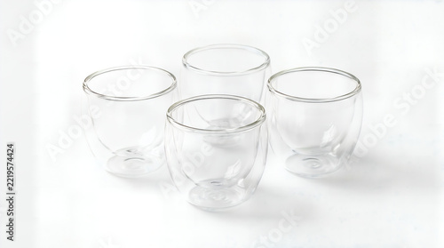 Group of clear insulated glass cups for espresso and cappuccino, minimalist cafe tableware