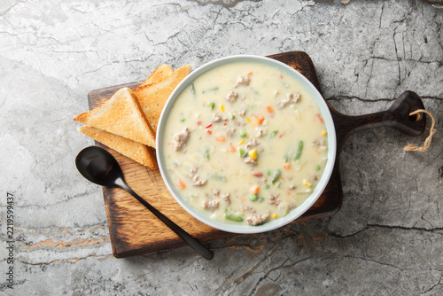 Shepherd's Pie Soup has lean ground beef, veggies and seasonings simmered in a delicious cream stock closeup on the plate on the table. Horizontal top view from above