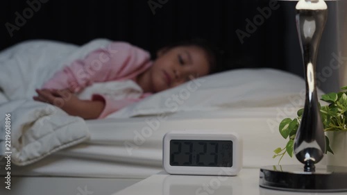 tired preschool child girl having trouble sleeping in a bed late at night, insomnia concept

