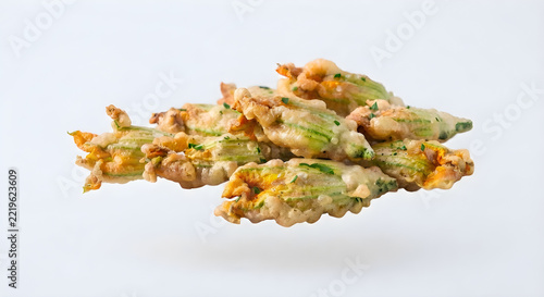 Fresh zucchini flowers in a white background isolated
