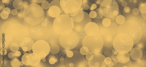 Golden bokeh background with glowing circles for festive holiday