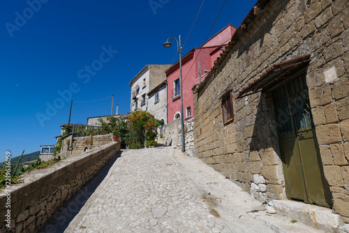 A narrow street winding between the old buildings of Montesarchio, a medieval town in southern Italy.