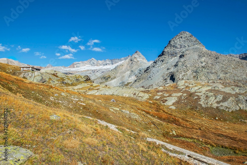 trail in french alpine mountains with a glacier in background  a shelter unde...