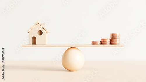 Wooden house model, egg and stacked coins representing home savings, property investment and financial security