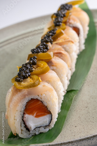 Gourmet sushi roll with salmon filling, wrapped in white fish