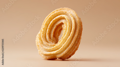 Cookie rests vertically on a minimalist neutral backdrop displaying crisp details and delicate golden textures.