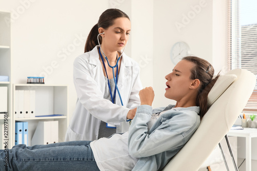 Medical diagnosis and respiratory health, doctor using stethoscope to examine...