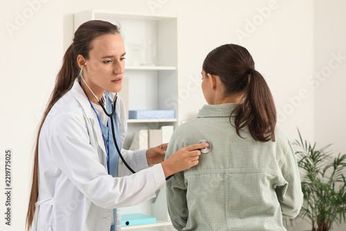 Medical examination and healthcare checkup, female doctor using stethoscope t...