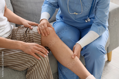 Physical therapy and medical consultation, doctor examining patient knee inju...