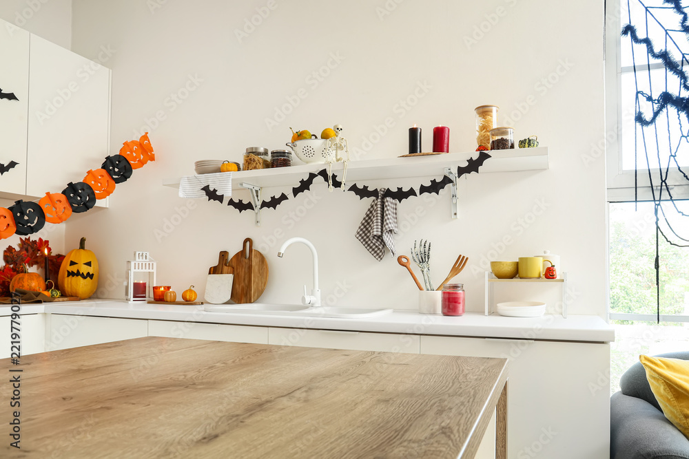 Fototapeta premium Halloween home decor, festive kitchen interior with pumpkins and bat garlands for autumn holiday celebration and seasonal party preparation
