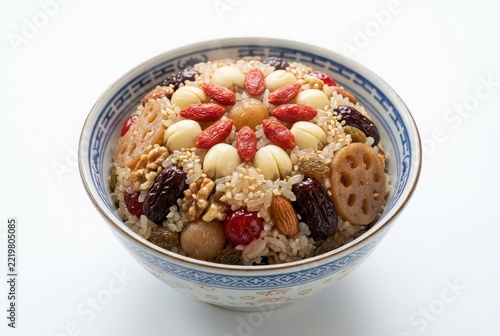 Traditional Chinese Eight-Treasure Rice Pudding with Red Dates, Goji Berries, and Lotus Seeds in a Ceramic Bowl