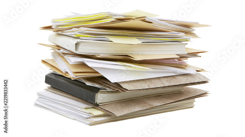 Large messy stack of assorted paper documents and folders with a black binder