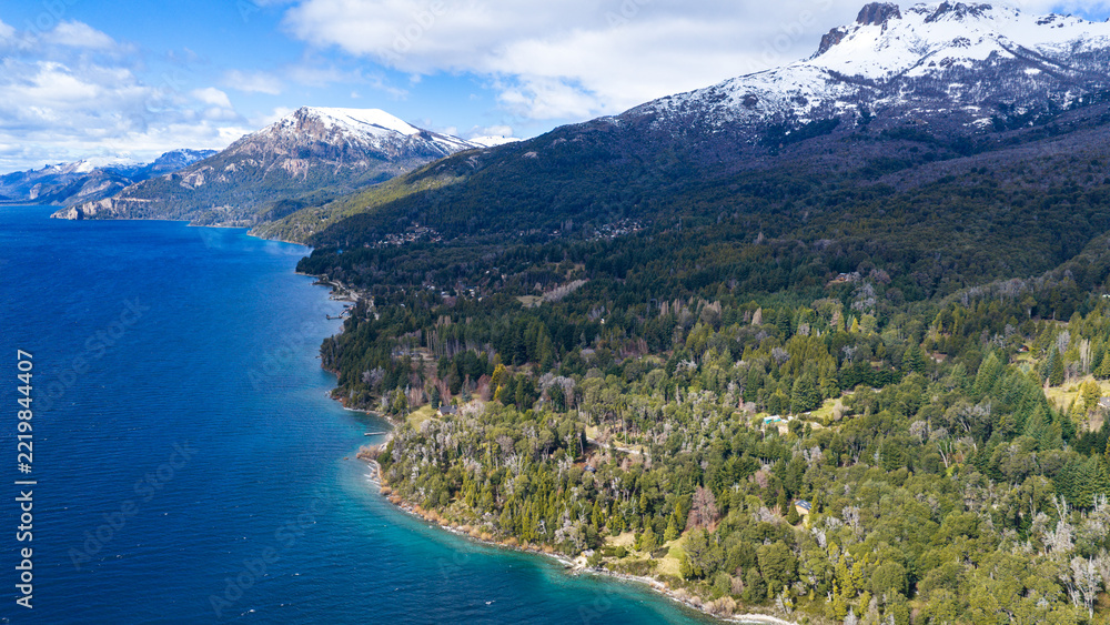 Fototapeta premium Villa Traful Lake Shoreline and Dense Andean Forests, Neuquén Province, Argentina, in Bright Daylight.