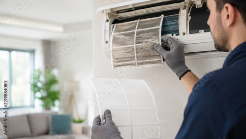 Home hvac repairman cleans air conditioner filter for healthier indoor air comfort