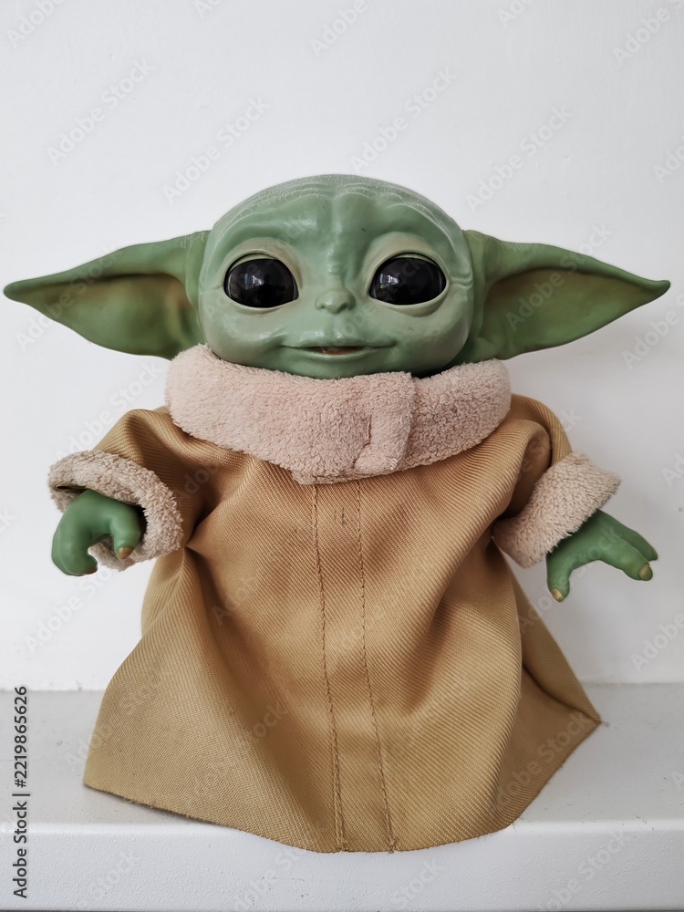 Naklejka premium Rome, Italy - October 9, 2026, Grogu, also known as Baby Yoda, a fictional character from the television series The Mandalorian, set in the Star Wars universe, displayed on a flatbed.