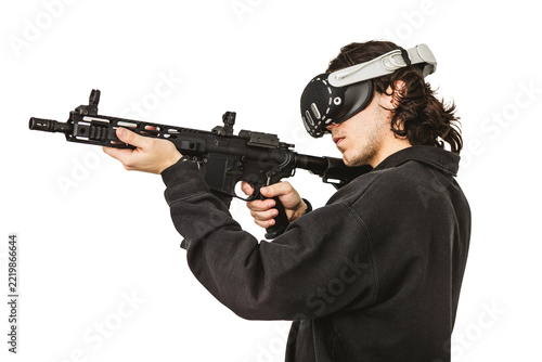 Man wearing virtual reality headset aiming AR-15 rifle controller in VR training simulation
