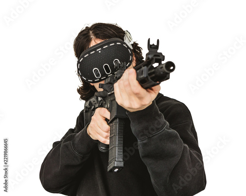 Man wearing virtual reality headset aiming AR-15 rifle controller in VR training simulation
