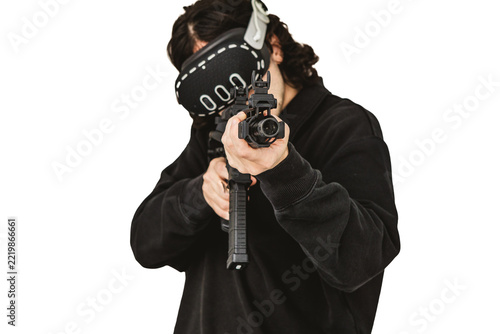 Man wearing virtual reality headset aiming AR-15 rifle controller in VR training simulation