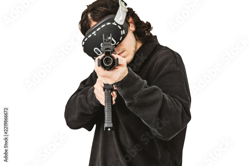 Man wearing virtual reality headset aiming AR-15 rifle controller in VR training simulation