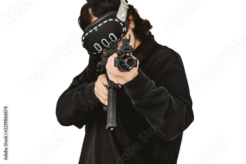 Man wearing virtual reality headset aiming AR-15 rifle controller in VR training simulation