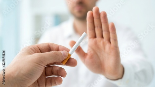 Person refusing to smoke a cigarette, close up of hands.