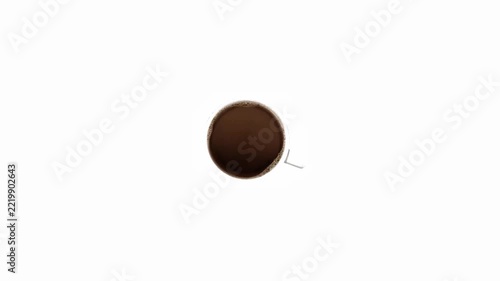 Top view of coffee mug with hot steaming coffee swirling isolated on a white background.