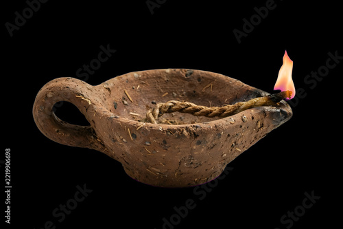 burning candle on black background