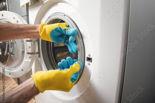 Caucasian master repairing a washing machine. Maintenance
