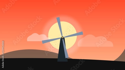 Windmill Silhouette at Sunset with Sun and Clouds.