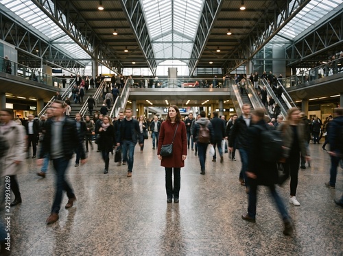 Busy woman waiting at modern train station during rush hour
