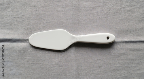 White plastic spatula on textured gray surface mockup, blank spaces for text