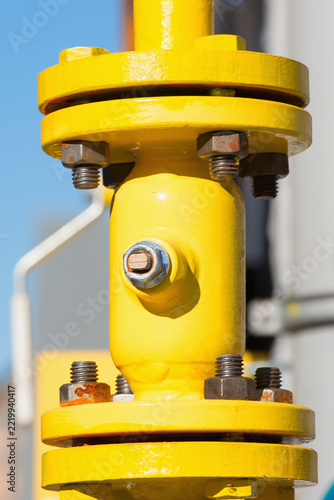 Pipe, flanges and valve on a gas pipeline to a residential building, vertical photo