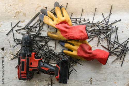 Cordless electric drill/screwdriver for driving screws and drilling; wall plugs and screws for home repairs.
