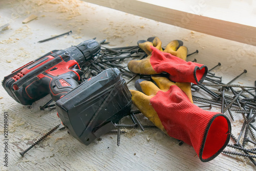 Cordless electric drill/screwdriver for driving screws and drilling; wall plugs and screws for home repairs.