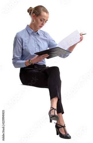 Young and successful businesswoman sitting and reading some papers, isolated on white and transparent background.