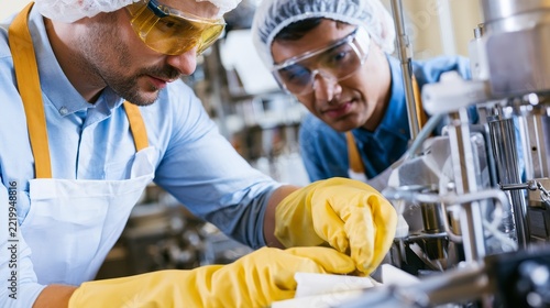 Two scientists work closely in a lab setting