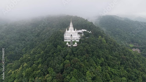 Aerial view from drone of the white pagoda and temple in the mountain on cloudy day