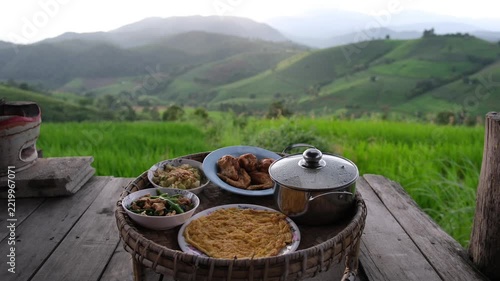 A set of Thai traditional dining table with rice terrace and mountain views