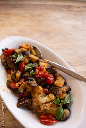 Cooked eggplant caponata in ceramic platter