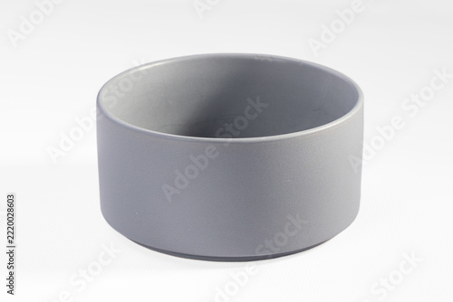 Fotografie Empty grey ceramic bowl with straight cylindrical sides and matte stoneware fini