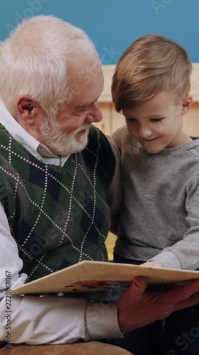 A Grandfather is reading to his Grandson in a cozy and warm setting filled with love and care