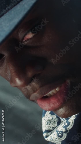 Close up view of suspicious, frightened Afro-American man in a cap constantly looking around. Chasing, outside the law. Danger, being a criminal. Camera stabilizer shot