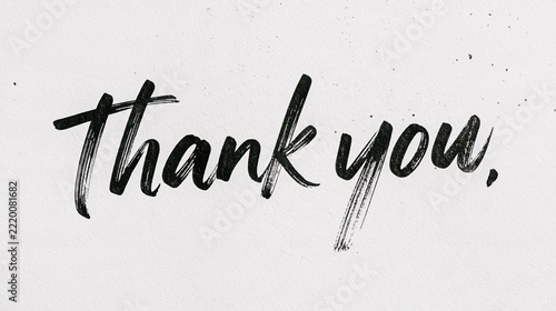 Black brush stroke lettering of the words thank you on a textured white paper background surface