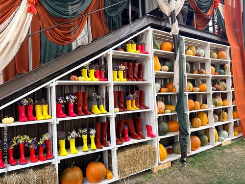 Autumn Farm Photo Zone with White Shelves, Rubber Boots, and Pumpkins